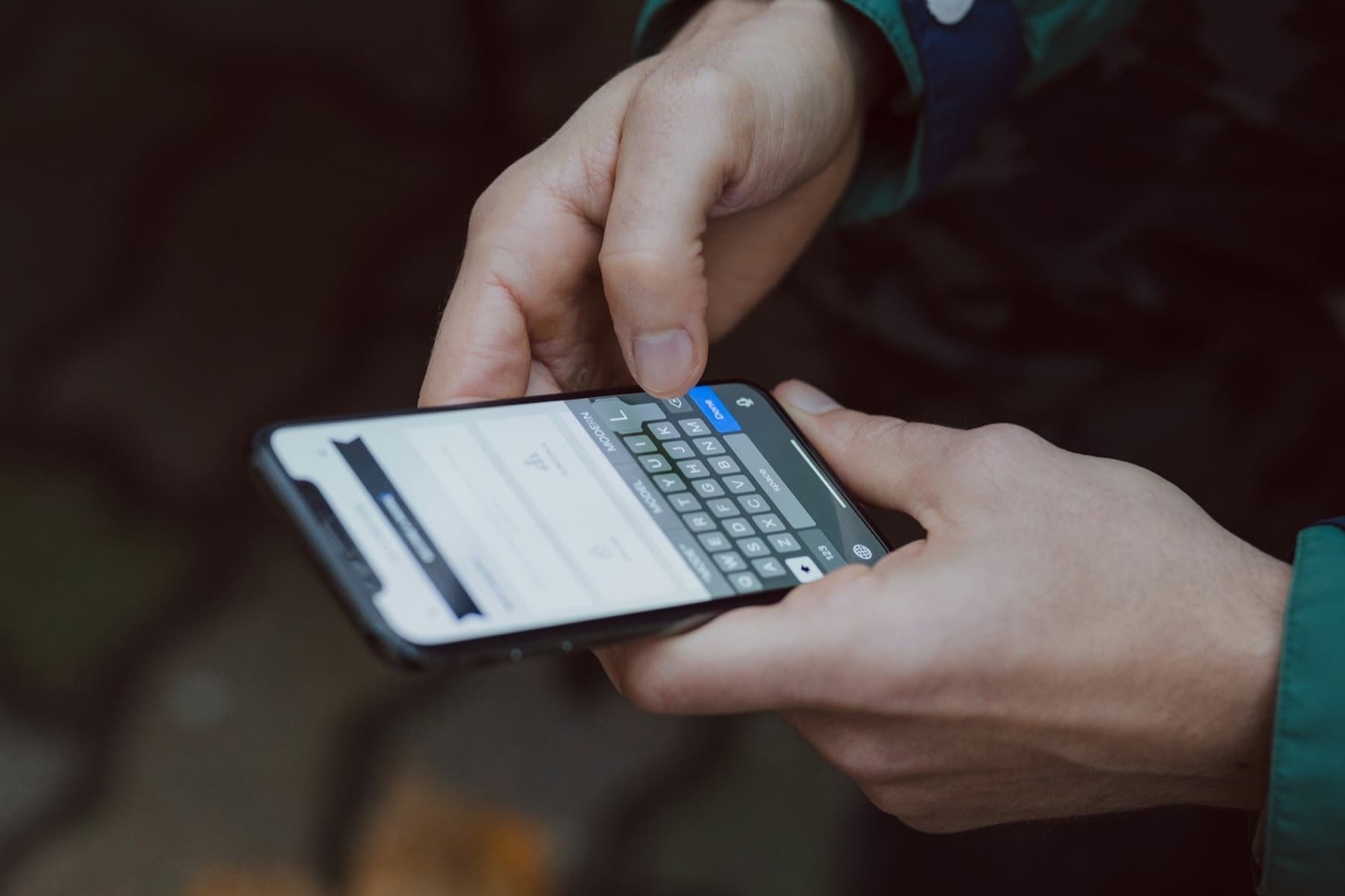 Person typing into a form on a smartphone